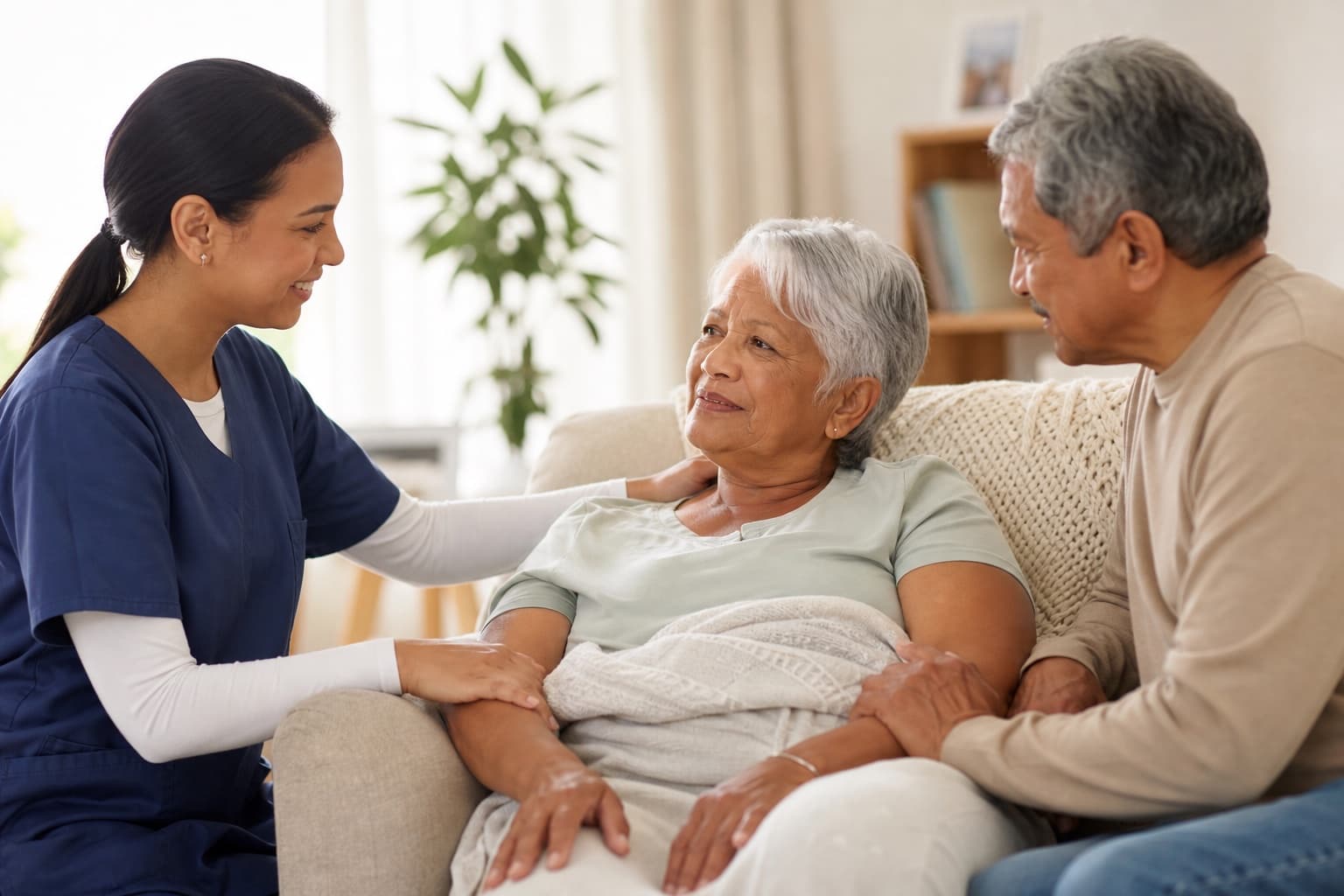 Hospice professional gently supporting an older adult and family member in a calm home setting